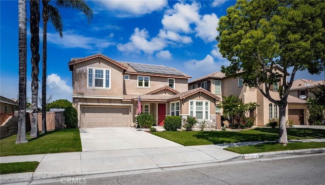 13014 Bermuda Ave, Chino, CA 91710 - view of front of home featuring concrete driveway, a garage, stucco siding, and solar panels