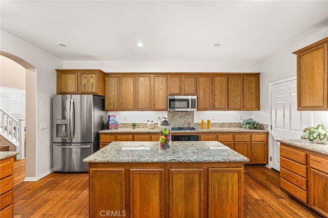 13014 Bermuda Ave, Chino, CA 91710 - kitchen with stainless steel appliances, dark wood-type flooring, brown cabinets, and recessed lighting