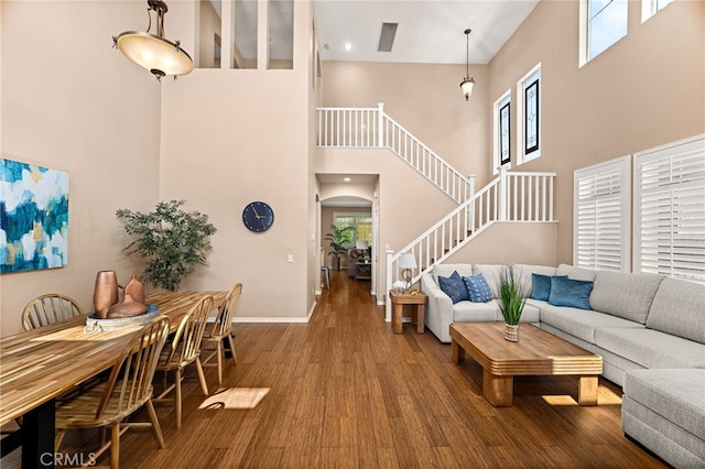 13014 Bermuda Ave, Chino, CA 91710 - living room featuring a towering ceiling, stairs, wood finished floors, and arched walkways