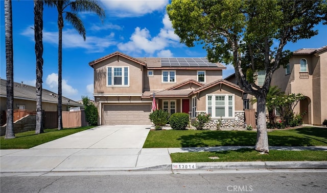 13014 Bermuda Ave, Chino, CA 91710 - view of front of house with stucco siding, driveway, roof mounted solar panels, an attached garage, and a tiled roof