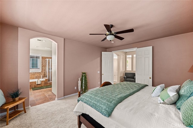 13014 Bermuda Ave, Chino, CA 91710 - bedroom featuring arched walkways, light carpet, a ceiling fan, and ensuite bath