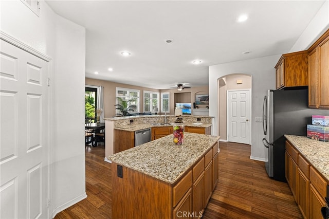 13014 Bermuda Ave, Chino, CA 91710 - kitchen featuring stainless steel appliances, a kitchen island, brown cabinetry, dark wood-style flooring, and recessed lighting