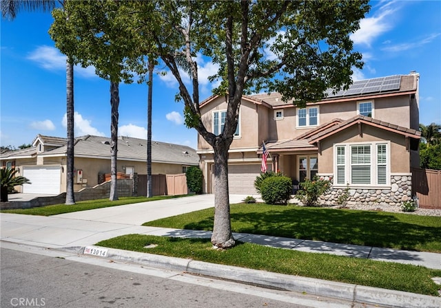 13014 Bermuda Ave, Chino, CA 91710 - traditional home with driveway, stucco siding, an attached garage, and solar panels