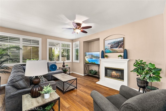 13014 Bermuda Ave, Chino, CA 91710 - living room with ceiling fan, wood finished floors, and a glass covered fireplace