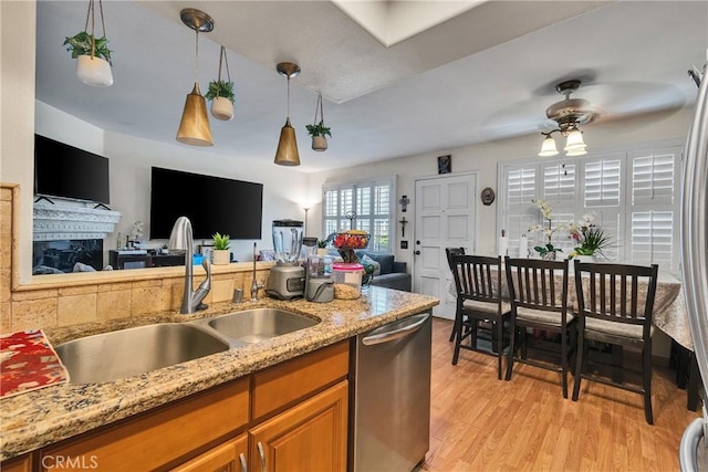 12012 Sproul St Unit 1/2, Norwalk, CA 90650 - kitchen featuring stainless steel dishwasher, open floor plan, brown cabinets, and a ceiling fan