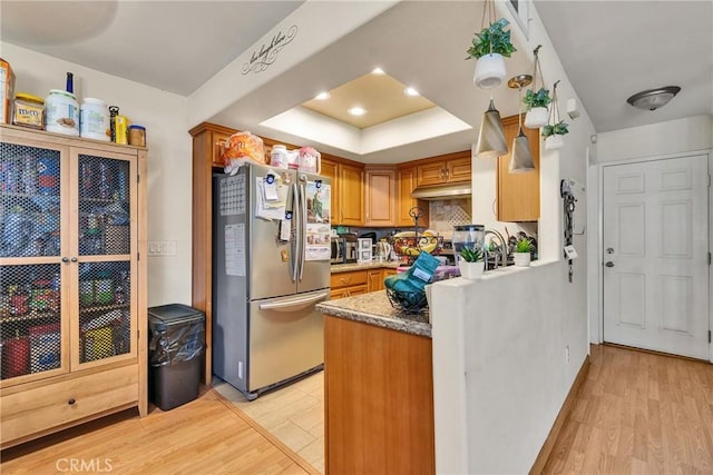 12012 Sproul St Unit 1/2, Norwalk, CA 90650 - kitchen featuring freestanding refrigerator, light wood finished floors, a tray ceiling, a peninsula, and recessed lighting