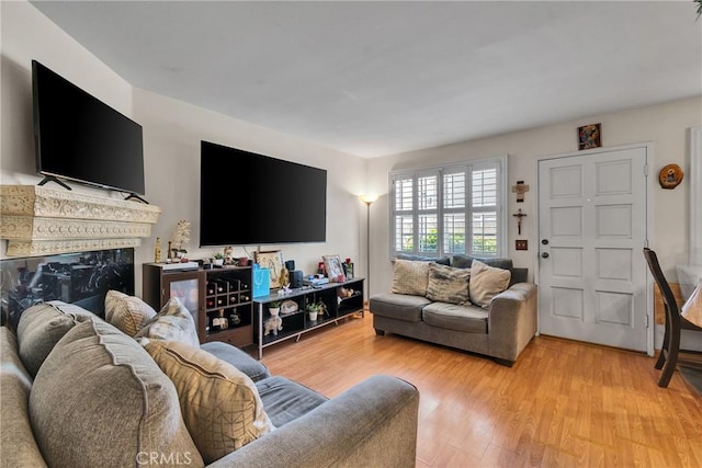 12012 Sproul St Unit 1/2, Norwalk, CA 90650 - living room featuring a fireplace and light wood-style floors