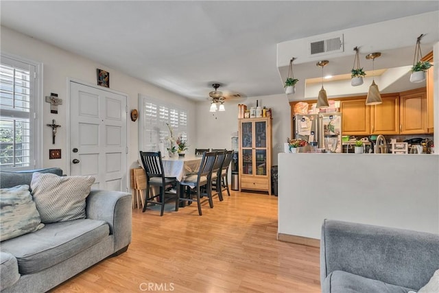 12012 Sproul St Unit 1/2, Norwalk, CA 90650 - living area with healthy amount of natural light, light wood finished floors, and ceiling fan