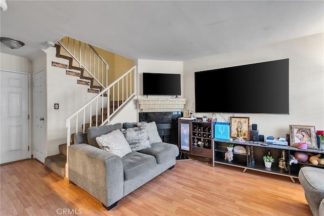 12012 Sproul St Unit 1/2, Norwalk, CA 90650 - living area with stairway, wood finished floors, and a fireplace