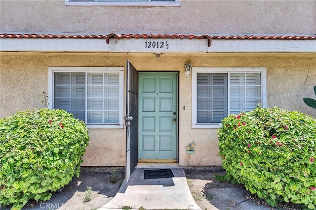 12012 Sproul St Unit 1/2, Norwalk, CA 90650 - doorway to property featuring stucco siding