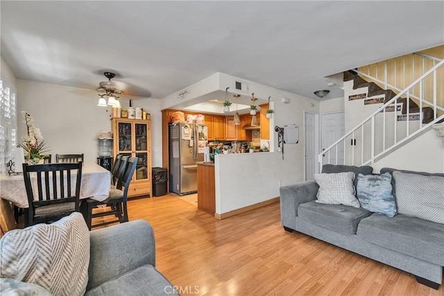 12012 Sproul St Unit 1/2, Norwalk, CA 90650 - living room featuring light wood-type flooring, a ceiling fan, and stairway