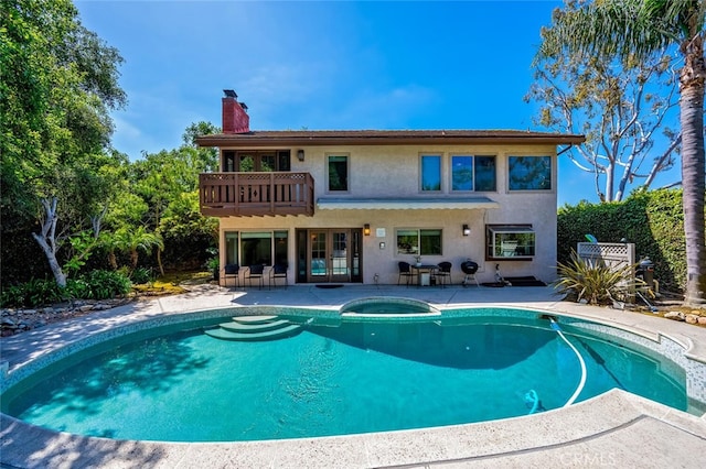 27681 Paseo Esteban, San Juan Capistrano, CA 92675 - back of house with french doors, stucco siding, a patio, a chimney, and a balcony