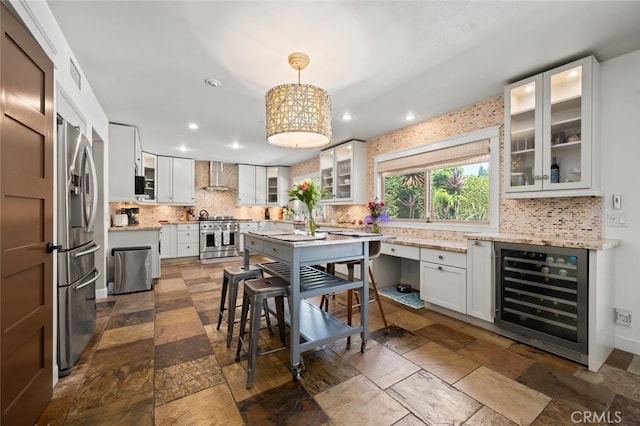 27681 Paseo Esteban, San Juan Capistrano, CA 92675 - kitchen with beverage cooler, wall chimney range hood, appliances with stainless steel finishes, decorative backsplash, and dark stone finish flooring