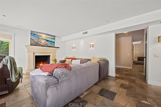 27681 Paseo Esteban, San Juan Capistrano, CA 92675 - living room featuring stone tile flooring and a lit fireplace