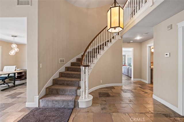 27681 Paseo Esteban, San Juan Capistrano, CA 92675 - stairway featuring stone tile flooring and a towering ceiling
