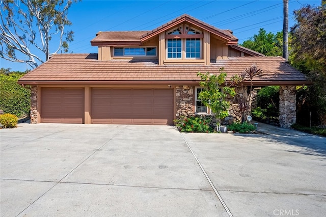 27681 Paseo Esteban, San Juan Capistrano, CA 92675 - view of front of house with stone siding, driveway, and a tile roof