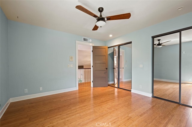 27681 Paseo Esteban, San Juan Capistrano, CA 92675 - unfurnished bedroom with multiple closets, light wood-type flooring, and ceiling fan