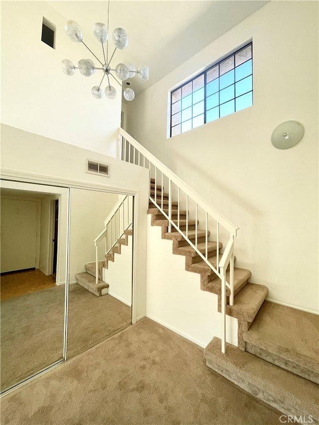640 S Lake Ave Unit 306, Pasadena, CA 91106 - stairs with a towering ceiling, carpet, and a chandelier