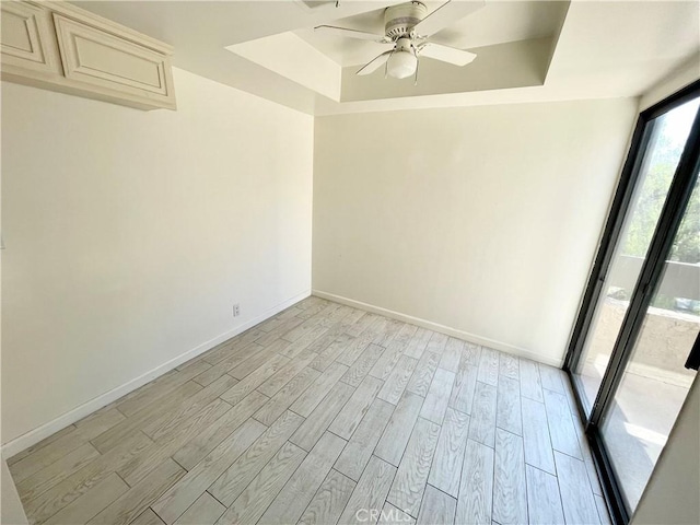 640 S Lake Ave Unit 306, Pasadena, CA 91106 - spare room with a raised ceiling, light wood-style floors, and a ceiling fan