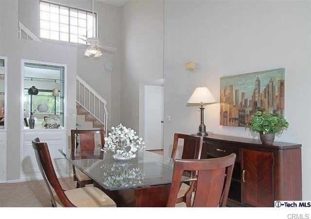 640 S Lake Ave Unit 306, Pasadena, CA 91106 - dining area featuring a towering ceiling and stairs
