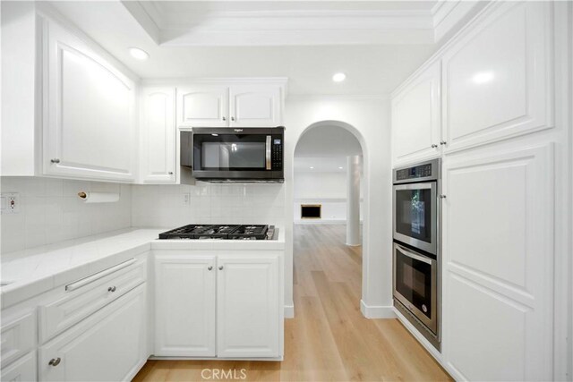 734 Puma Canyon Ln, Glendora, CA 91740 - kitchen with appliances with stainless steel finishes, arched walkways, white cabinets, backsplash, and recessed lighting