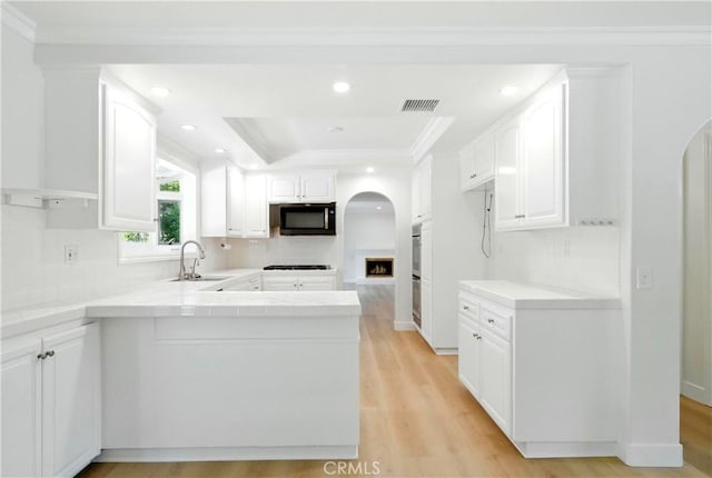 734 Puma Canyon Ln, Glendora, CA 91740 - kitchen with a peninsula, white cabinetry, arched walkways, tile counters, and recessed lighting