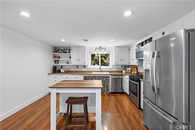 2805 Via Montecito, San Clemente, CA 92672 - kitchen featuring stainless steel appliances, open shelves, white cabinets, dark wood-style flooring, and recessed lighting