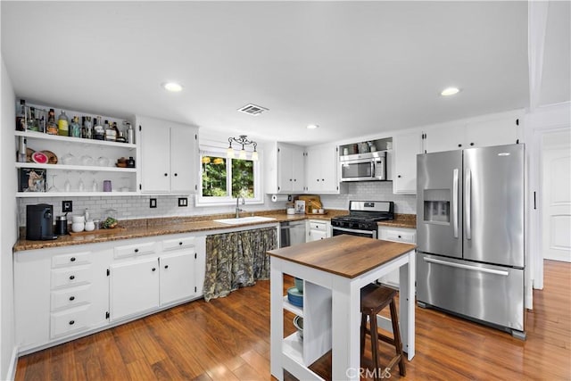 2805 Via Montecito, San Clemente, CA 92672 - kitchen with appliances with stainless steel finishes, open shelves, backsplash, dark wood-style flooring, and recessed lighting