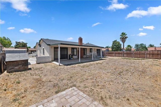 2294 Daisy Way, Hemet, CA 92545 - rear view of property with a patio, a fenced backyard, a chimney, and stucco siding