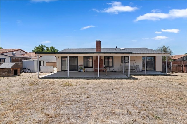 2294 Daisy Way, Hemet, CA 92545 - rear view of property featuring a patio, a chimney, and stucco siding