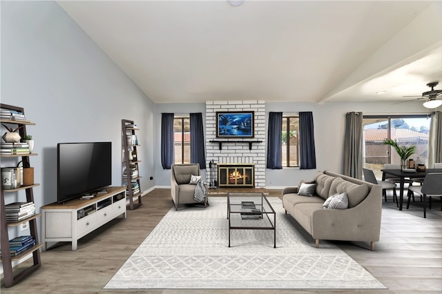 2294 Daisy Way, Hemet, CA 92545 - living room featuring lofted ceiling, light wood-type flooring, a ceiling fan, and a fireplace