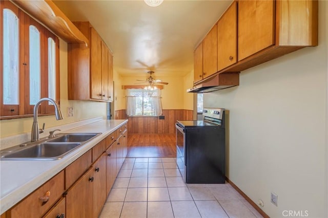 2001 W Jan Way, Santa Ana, CA 92704 - kitchen featuring stainless steel electric range oven, under cabinet range hood, wainscoting, light countertops, and a ceiling fan