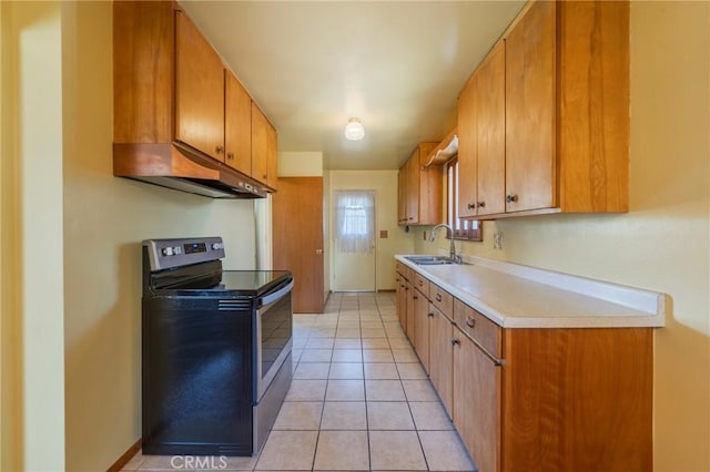 2001 W Jan Way, Santa Ana, CA 92704 - kitchen featuring electric range, under cabinet range hood, light countertops, and brown cabinetry