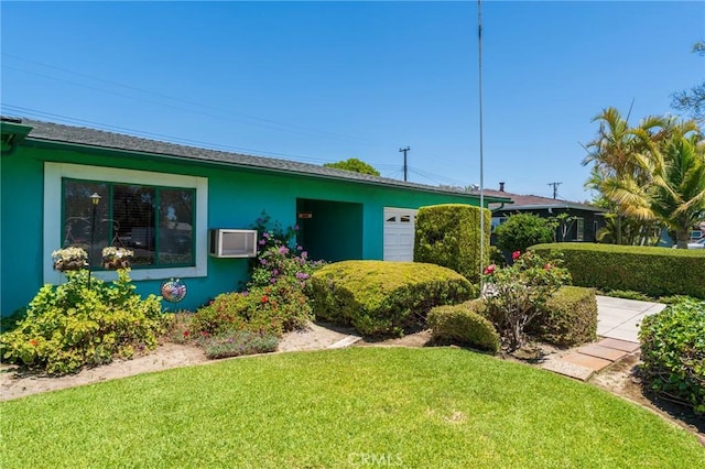 2001 W Jan Way, Santa Ana, CA 92704 - view of front of house with stucco siding, a garage, a front lawn, and an AC wall unit