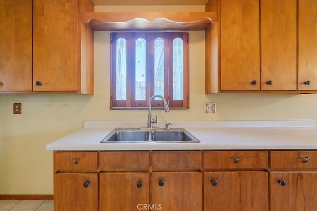2001 W Jan Way, Santa Ana, CA 92704 - kitchen with light countertops, light tile patterned floors, and brown cabinetry