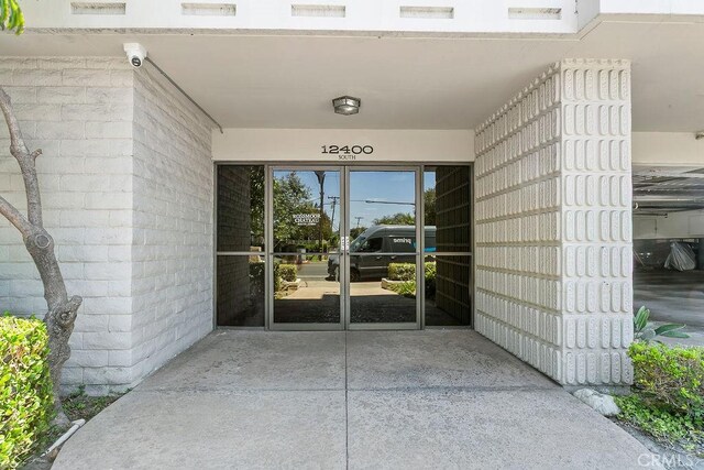 12400 Montecito Rd Unit 222, Seal Beach, CA 90740 - property entrance with a security system and french doors