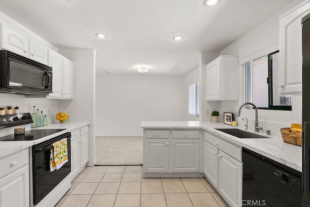 12400 Montecito Rd Unit 222, Seal Beach, CA 90740 - kitchen featuring black appliances, white cabinetry, a peninsula, light tile patterned floors, and light carpet