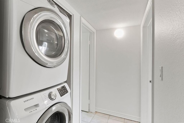 12400 Montecito Rd Unit 222, Seal Beach, CA 90740 - laundry area with stacked washer / dryer, light tile patterned flooring, and a textured ceiling