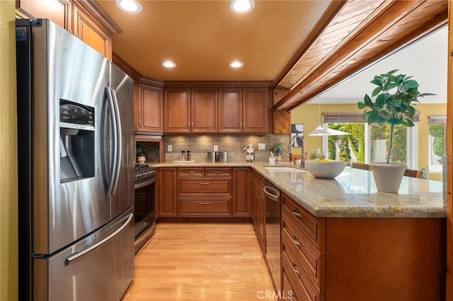 26017 Redbluff Dr, Calabasas, CA 91302 - kitchen featuring appliances with stainless steel finishes, light wood-type flooring, brown cabinets, a peninsula, and recessed lighting