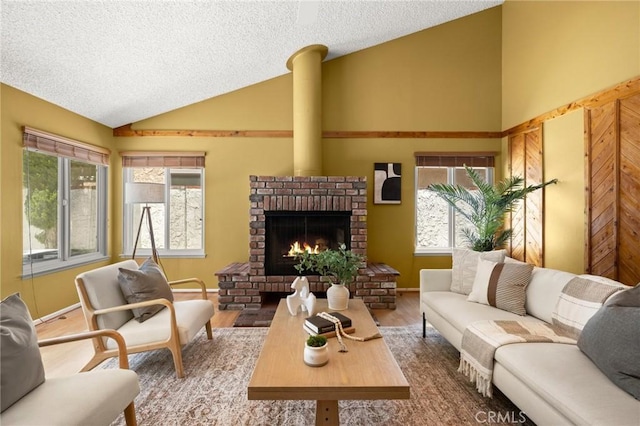 26017 Redbluff Dr, Calabasas, CA 91302 - living room featuring vaulted ceiling, a brick fireplace, a textured ceiling, and wood finished floors