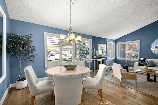 26017 Redbluff Dr, Calabasas, CA 91302 - dining room with a textured ceiling, a chandelier, wood finished floors, and lofted ceiling