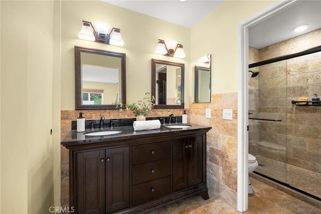 26017 Redbluff Dr, Calabasas, CA 91302 - bathroom with double vanity, a shower stall, tile walls, and wainscoting