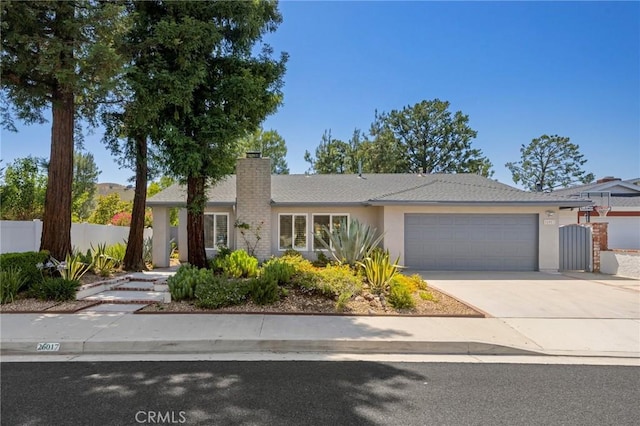 26017 Redbluff Dr, Calabasas, CA 91302 - ranch-style home with an attached garage, concrete driveway, stucco siding, and a chimney
