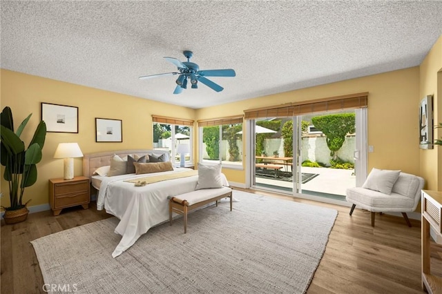 26017 Redbluff Dr, Calabasas, CA 91302 - bedroom featuring access to exterior, wood finished floors, a textured ceiling, and ceiling fan