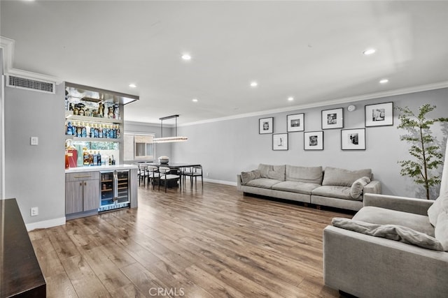 9778 Via Roma, Burbank, CA 91504 - living room featuring wine cooler, a dry bar, ornamental molding, recessed lighting, and light wood finished floors