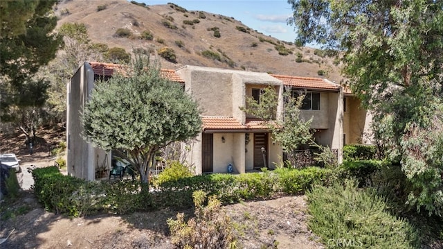 9778 Via Roma, Burbank, CA 91504 - back of property featuring a tiled roof, stucco siding, and a mountain view