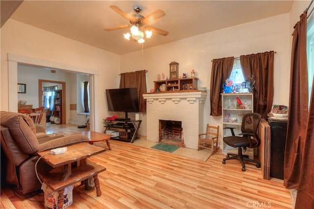 217 N Plumas St, Willows, CA 95988 - living room featuring a ceiling fan, wood finished floors, and a fireplace