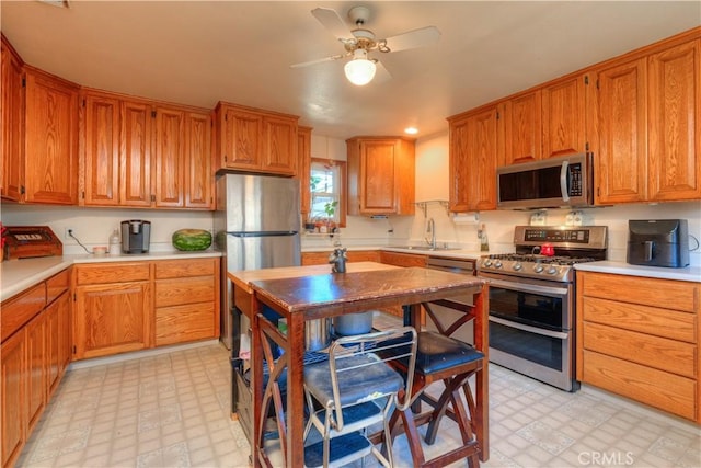217 N Plumas St, Willows, CA 95988 - kitchen with appliances with stainless steel finishes, light floors, a ceiling fan, and light countertops