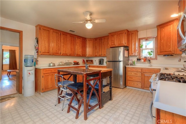 217 N Plumas St, Willows, CA 95988 - kitchen featuring stainless steel appliances, light floors, ceiling fan, and light countertops