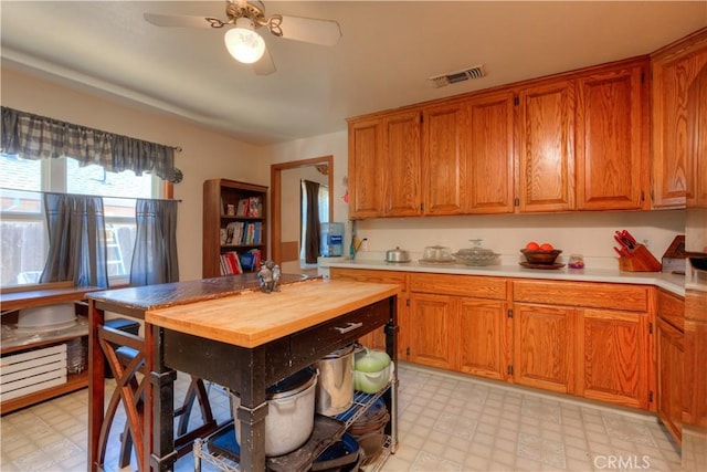 217 N Plumas St, Willows, CA 95988 - kitchen with light flooring, a ceiling fan, brown cabinetry, and butcher block countertops